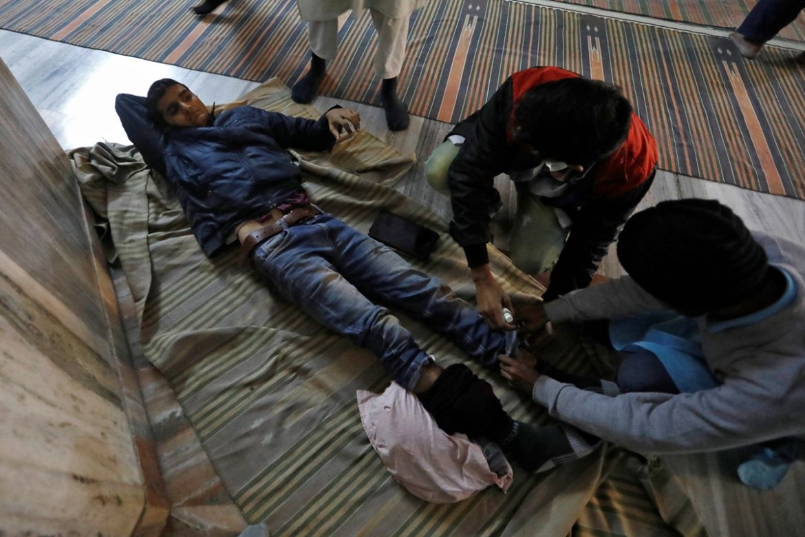 An injured man is treated inside a mosque after he was wounded in a protest against a new citizenship law, in New Delhi, India, December 15, 2019. REUTERS/Adnan Abidi