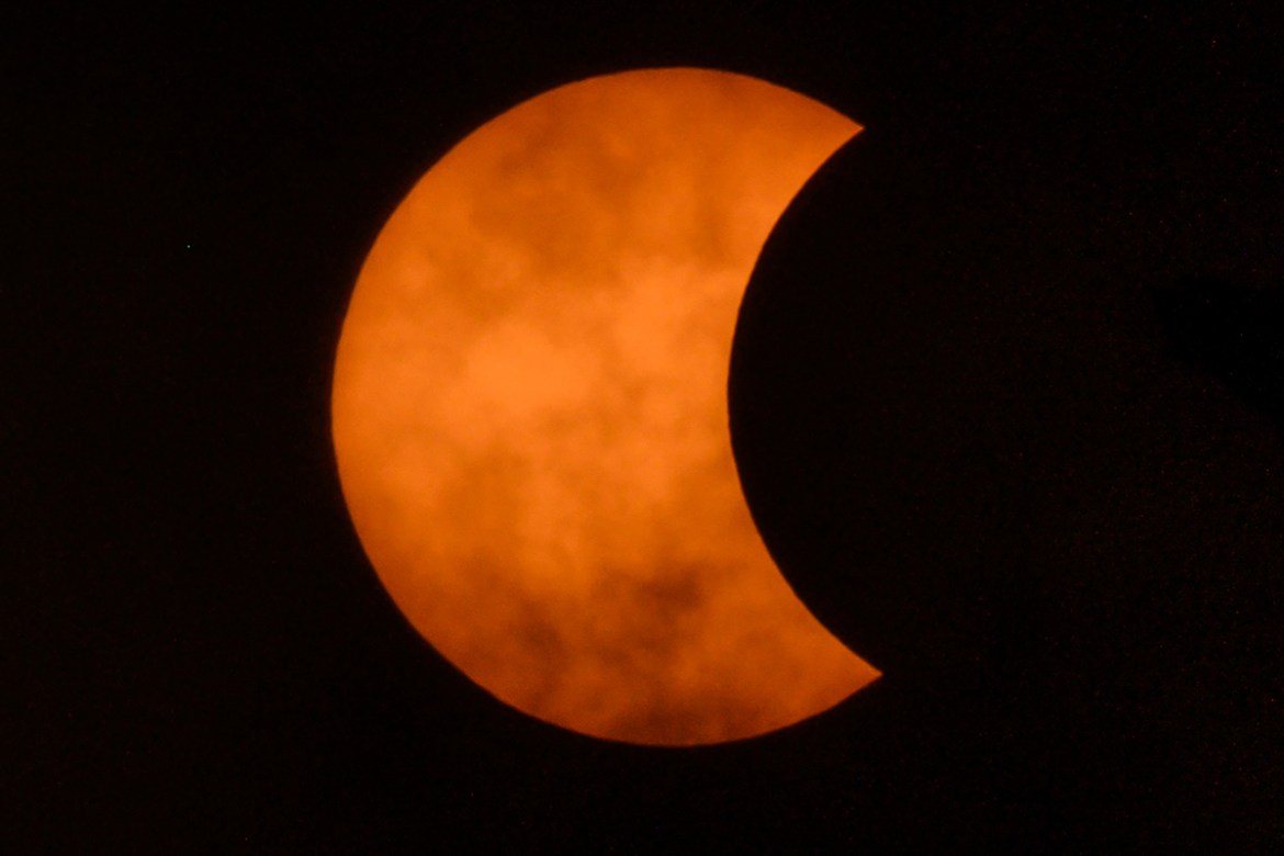 The moon moves in front of the sun in a rare "ring of fire" solar eclipse as seen from Bangkok on December 26, 2019. (Photo by Mladen ANTONOV / AFP)