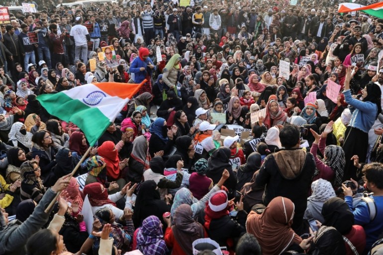 Demonstrators attend a protest against a new citizenship law, outside the Jamia Millia Islamia University in New Delhi
