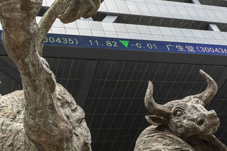 An electronic ticker board indicates stock figures beyond a bull statue at the Shenzhen Stock Exchange building in Shenzhen, China, on Wednesday, Sept. 4, 2019