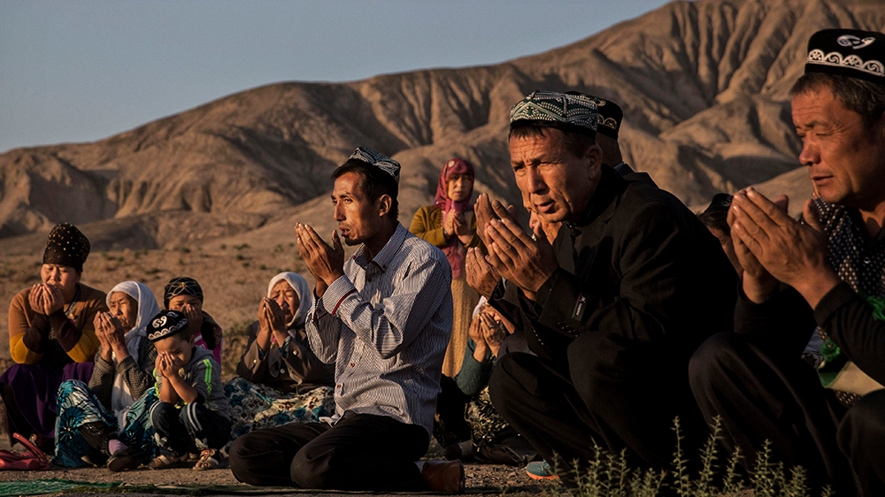 (CHINA OUT) A Uyghur family pray at the grave of a loved one on the morning of the Corban Festival on September 12, 2016 at a local shrine and cemetery in Turpan County, in the far western Xinjiang pr