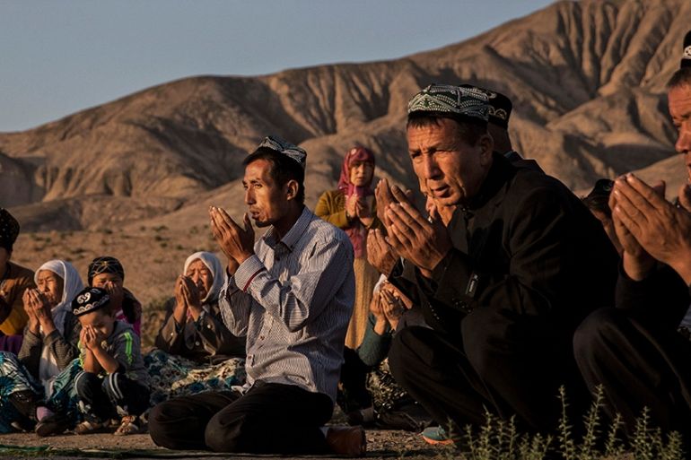 (CHINA OUT) A Uyghur family pray at the grave of a loved one on the morning of the Corban Festival on September 12, 2016 at a local shrine and cemetery in Turpan County, in the far western Xinjiang pr