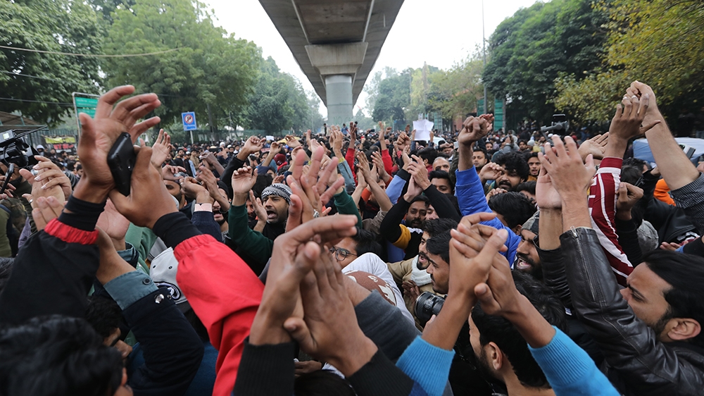  Indian protesters shout slogans outside the Jamia Millia Islamia University during a protest against the Citizenship (Amendment) Bill 2019 (CAB) in New Delhi, India, 16 December 2019. The bill will g
