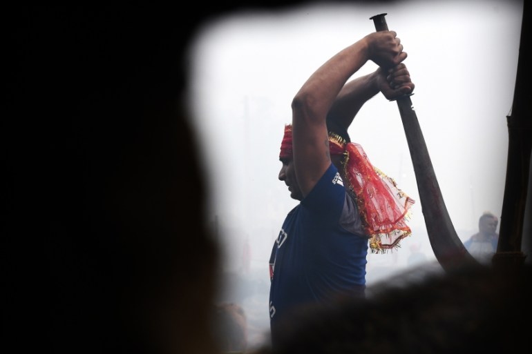 A Hindu devotee slaughters a buffalos as a offering during the Gadhimai Festival in Bariyarpur on December 3, 2019. Thousands of Hindu devotees gathered in southern Nepal for a festival believed to be
