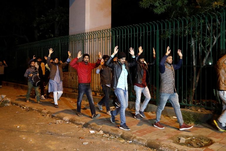 Students raising their hands leave the Jamia Milia University following a protest against a new citizenship law, in New Delhi, India, December 15, 2019. REUTERS/Adnan Abidi