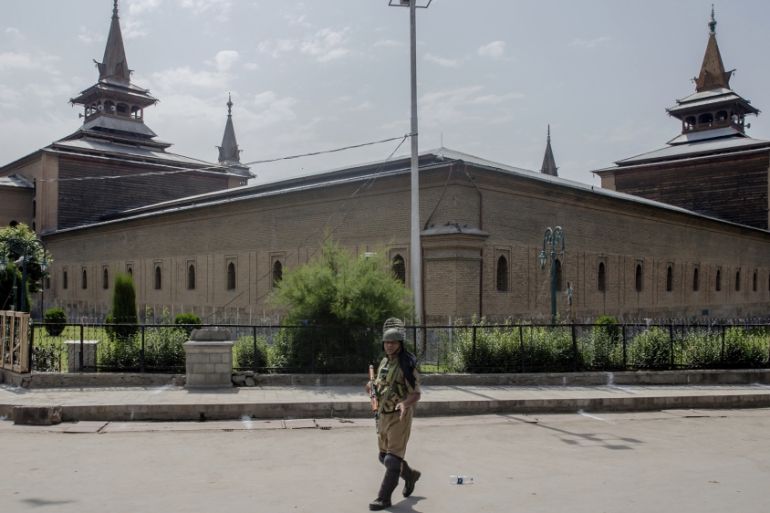 An Indian paramilitary soldier patrols outside the Jamia Masjid or Grand Mosque in Srinagar, Indian controlled Kashmir [Dar Yasin/AP Photo]