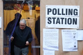 An elder leaves the garage of a residential house, converted to a poling station, to vote in the general election in South Croydon, in London, Britain, December 12, 2019