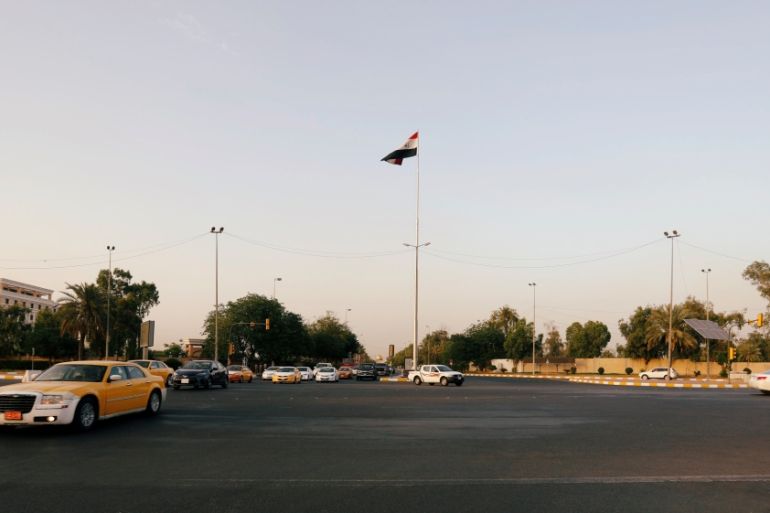 Cars drive past the Green Zone of Baghdad