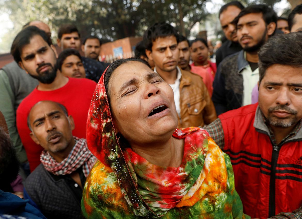 A relative of a victim of a fire that swept through a factory where laborers were sleeping, cries outside a hospital mortuary in New Delhi, India December 8, 2019. REUTERS/Adnan Abidi