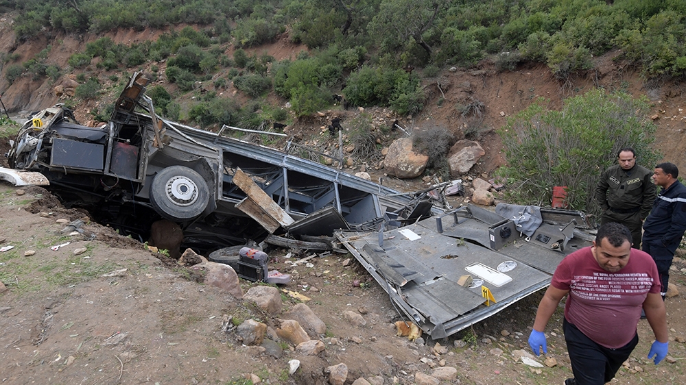 Tunisian security forces check the debris of a bus that plunged over a cliff into a ravine, in Ain Snoussi in northern Tunisia on December 1, 2019. - The bus, with 43 people on board had set off from 