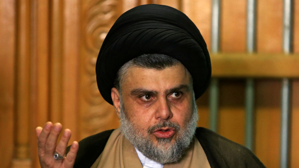 Iraqi Shi'ite cleric Moqtada al-Sadr speaks during a news conference with Iraqi politician Ammar al-Hakim, leader of the Hikma Current, in Najaf