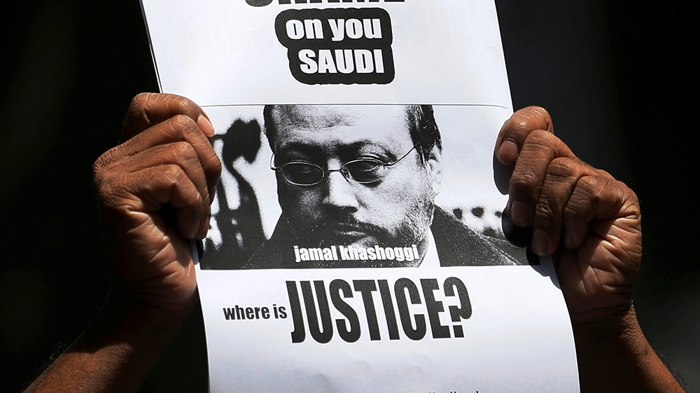 A member of Sri Lankan web journalist association holds a placard during a protest condemning the murder of slain journalist Jamal Khashoggi in front of the Saudi Embassy in Colombo, Sri Lanka October