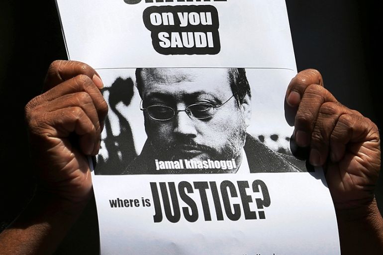 A member of Sri Lankan web journalist association holds a placard during a protest condemning the murder of slain journalist Jamal Khashoggi in front of the Saudi Embassy in Colombo, Sri Lanka October