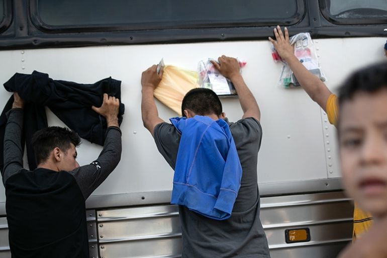 LOS EBANOS, TEXAS - JULY 02: Immigrants wait to be searched and then bussed to U.S. Border Patrol facility in McAllen after crossing the border from Mexico on July 02, 2019 in Los Ebanos, Texas. Hundr