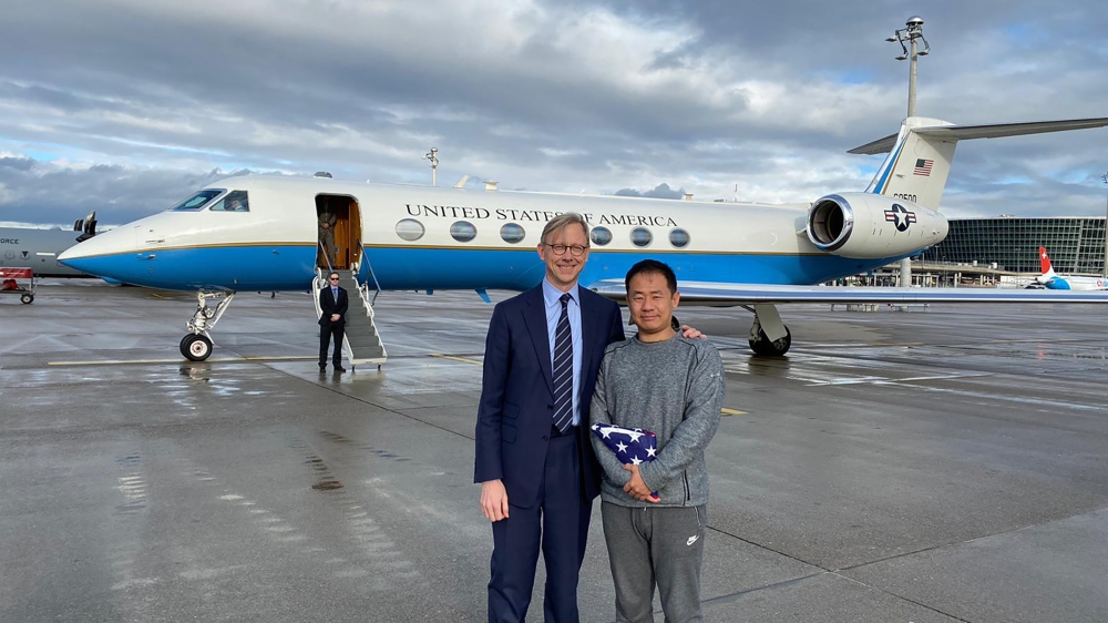 U.S. special representative for Iran, Brian Hook stands with Xiyue Wang in Zurich