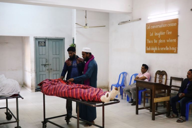 Relatives are seen at the morgue of Dhaka Medical College Hospital after a deadly fire in a plastic factory in Dhaka