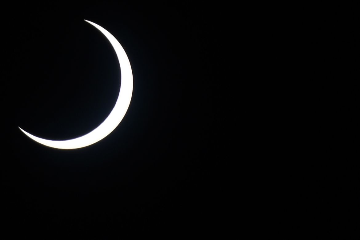 The moon covers the sun in a rare "ring of fire" solar eclipse as seen from Colombo on December 26, 2019. (Photo by LAKRUWAN WANNIARACHCHI / AFP)