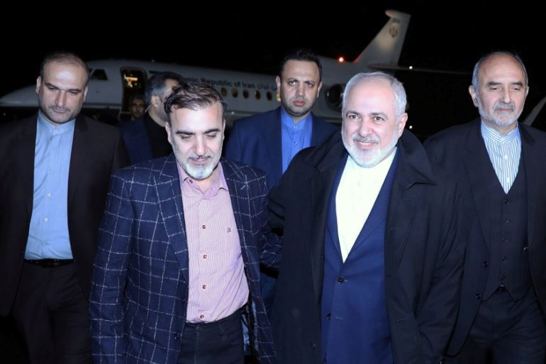Iran''s Foreign Minister Mohammad Javad Zarif walks with Iranian professor Massoud Soleimani as he arrives at Mehrabad airport, in Tehran