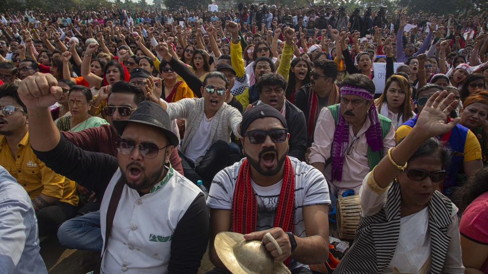 Indian artists and protesters shout slogans against the Citizenship Amendment Act in Gauhati, India, Sunday, Dec. 15, 2019. Protests have been continuing over a new law that grants citizenship based o