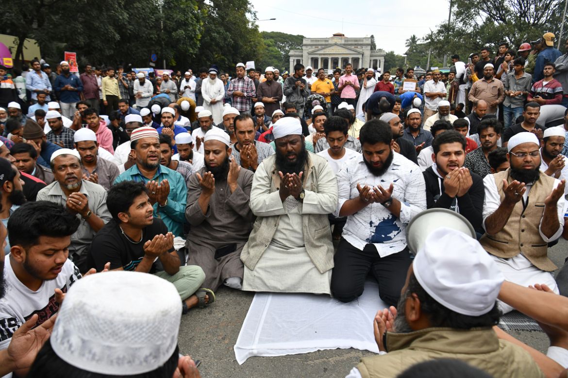Muslim protesters pray on the street near the Town Hall during a demonstration held against India''s new citizenship law in spite of a curfew in Bangalore on December 19, 2019. - Indians defied bans on