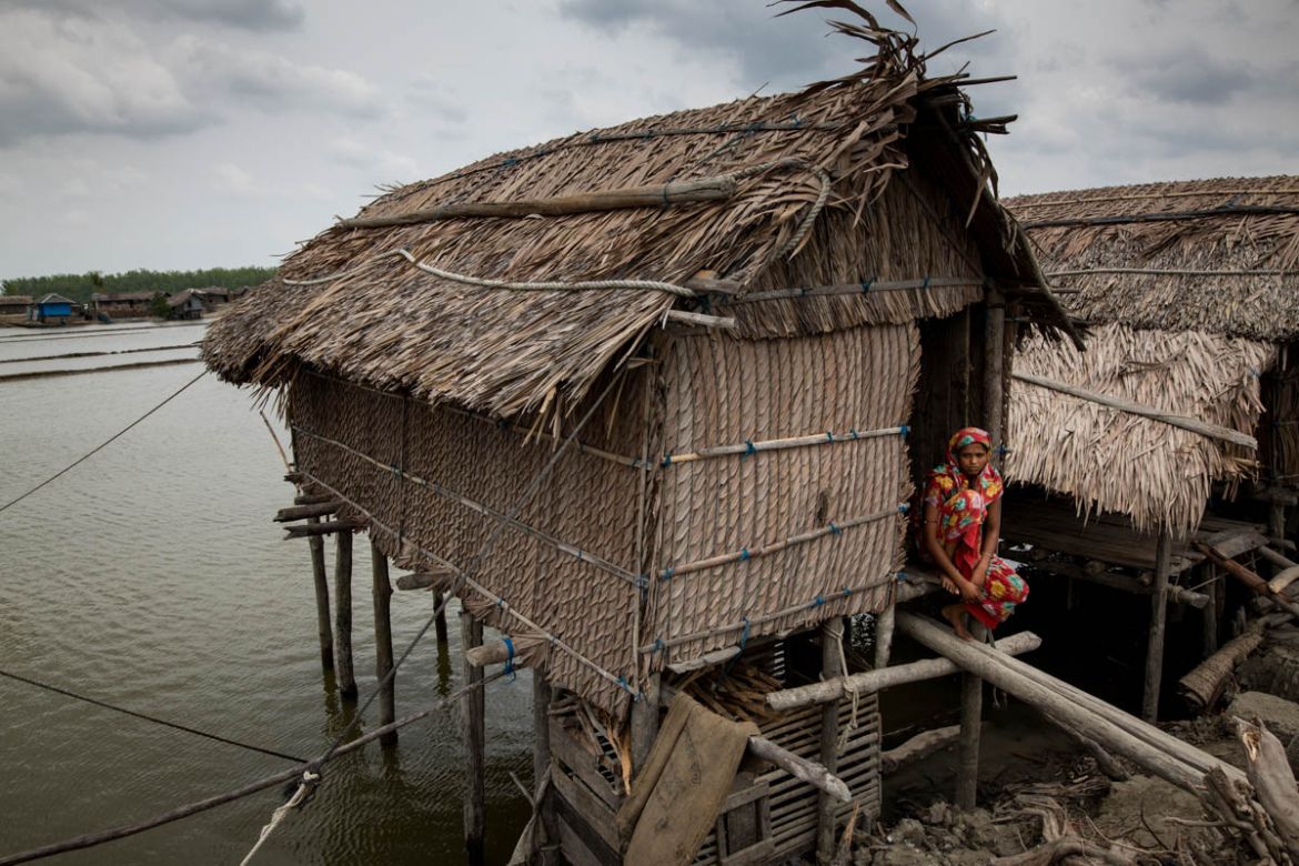 A woman who lost her houses by the river, now living in a temporary house on the river near Sundarban area of Bangladesh.