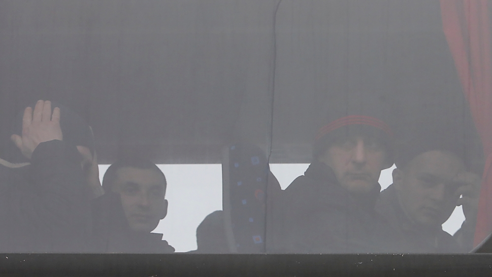 Men are seen inside a bus before prisoner of war exchange in Donetsk region