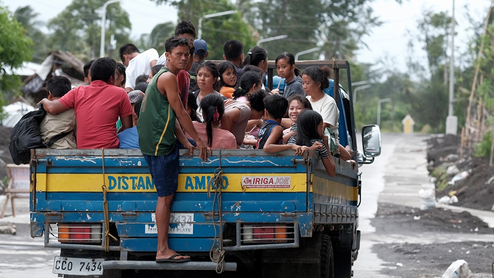 Villagers ride a truck as they are evacuated in anticipation of an approaching typhoon in Legaspi city, Albay province, Philippines, 02 December 2019. According to the latest government weather bureau