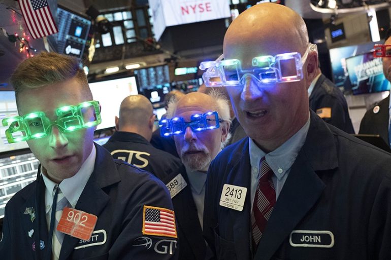 Stock traders wear New Year''s 2020 party glasses at New York Stock Exchange, Tuesday, Dec. 31, 2019