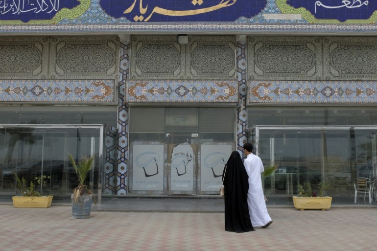 A Saudi couple arrives to an Iranian restaurant in Dammam, Saudi Arabia
