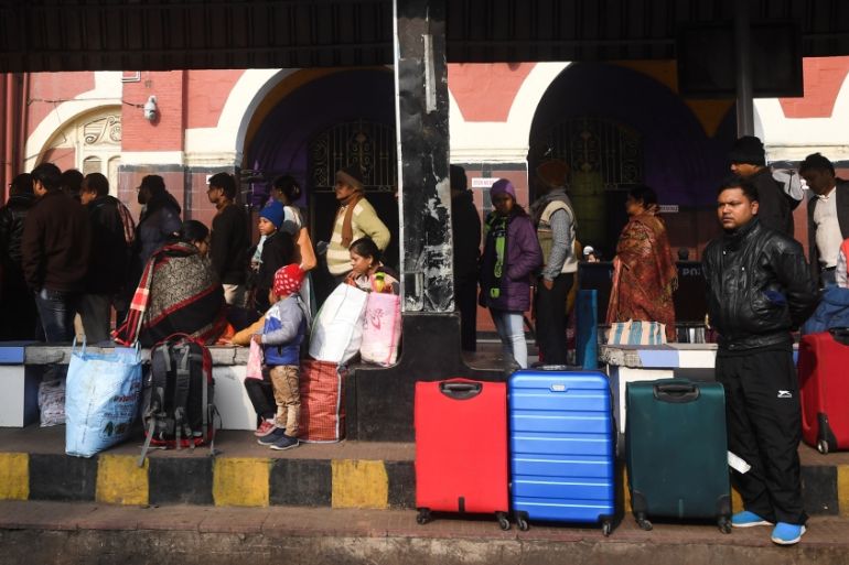 People wait for transportation outside the Howrah railway station during a nationwide general strike called by trade unions aligned with opposition parties to protest the Indian government''s economic