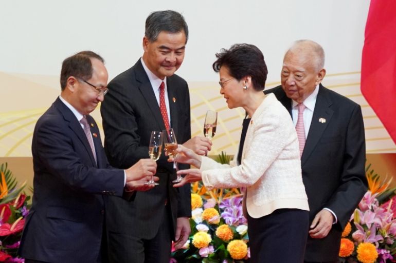 REFILE - CORRECTING BYLINE Hong Kong Chief Executive Carrie Lam raises a toast with Director of China''s Liaison Office in Hong Kong Wang Zhimin, next to Former Hong Kong Chief Executive Leung Chun-yin