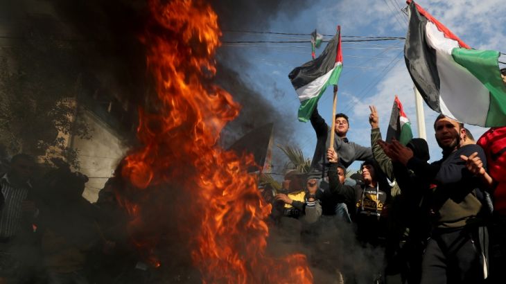 Palestinians protest as tires burn ahead of the announcement by U.S. President Donald Trump of his long-delayed Mideast peace plan, in Gaza City