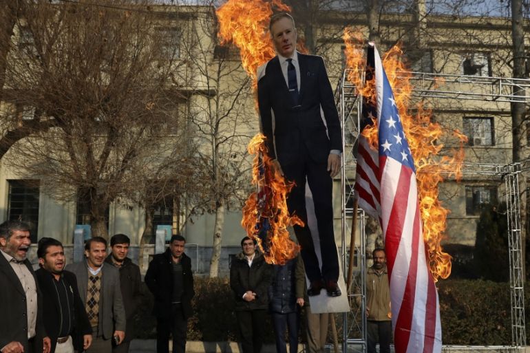 Pro-government protesters set fire to U.S. and British flags with a life size cut-out of Britain''s ambassador to Tehran Rob Macaire, in a gathering to commemorate the late Iranian Gen. Qassem Soleiman