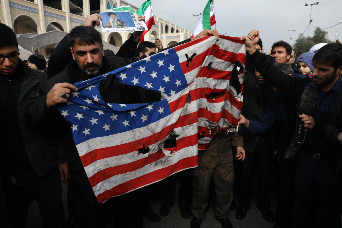 Protesters burn a U.S. flag during a demonstration over the U.S. airstrike in Iraq that killed Iranian Revolutionary Guard Gen. Qassem Soleimani, in Tehran, Iran, Jan. 3, 2020. Iran has vowed 