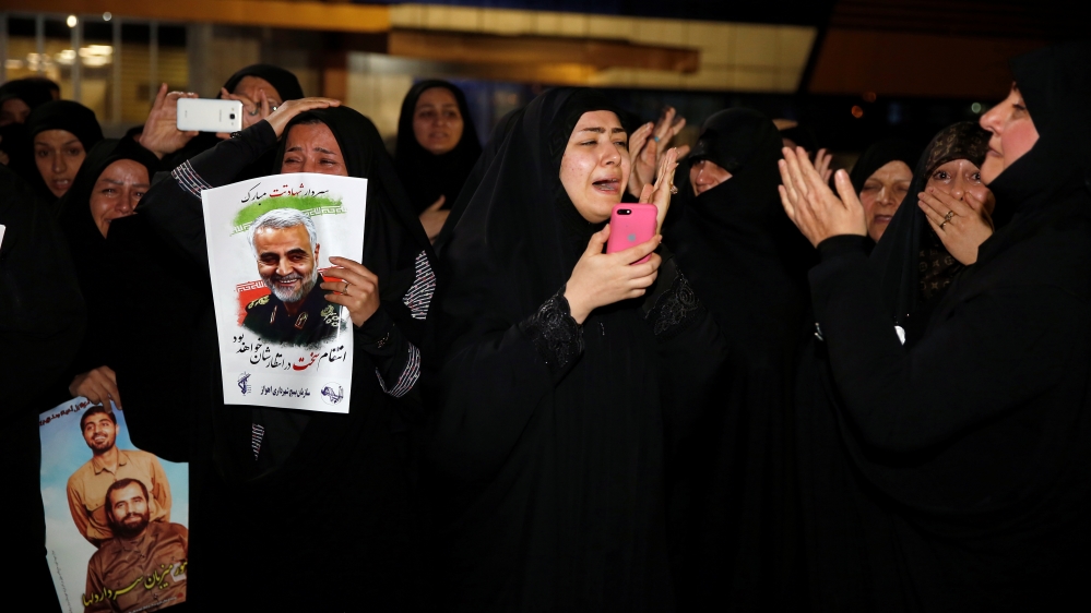 Iranian mourners react upon the arrival of bodies of the Iranian Major-General Qassem Soleimani, head of the elite Quds Force, and the Iraqi militia commander Abu Mahdi al-Muhandis, who were killed in