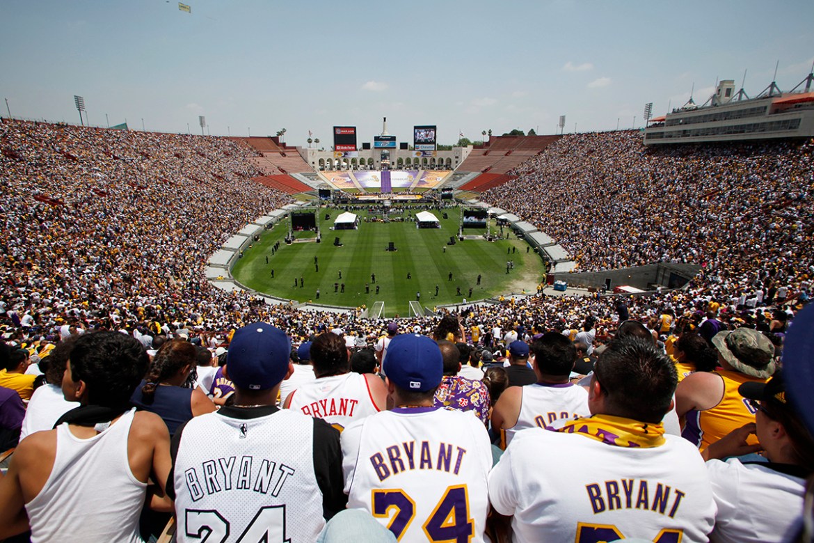 Fans wear Kobe Bryant jerseys at a rally in the Los Angeles Memorial Coliseum after the team paraded down Figueroa Street from Staples Center to the Coliseum as the Los Angeles Lakers celebrate their