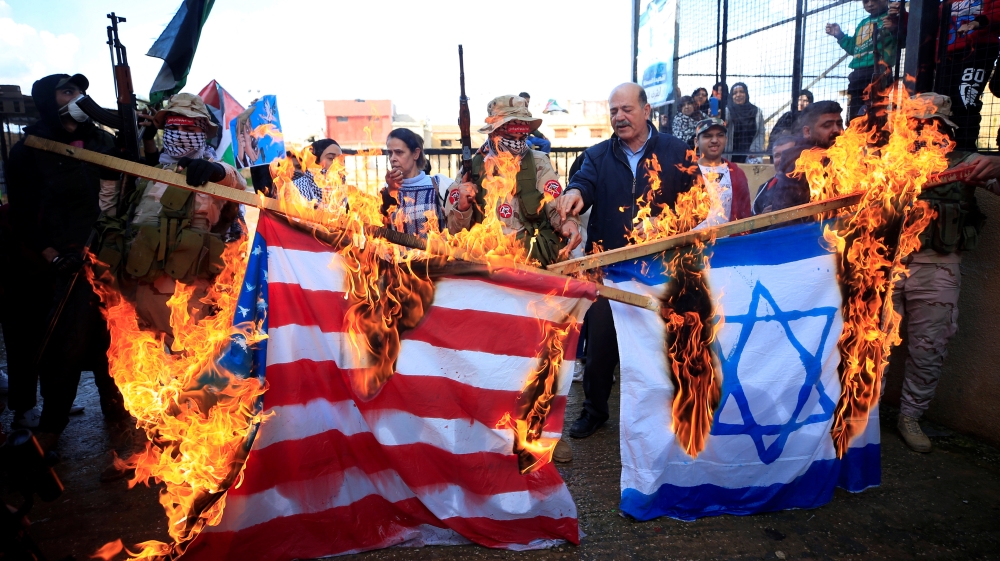 Demonstrators set fire to a makeshift Israeli and U.S. flag during a protest against U.S. President Donald TrumpÕs Middle East peace plan, in Ain al-Hilweh Palestinian refugee camp, near Sidon