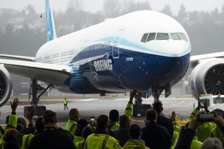 Boeing employees and guests welcome a Boeing 777X airplane returning from its inaugural flight at Boeing Field in Seattle, Washington on January 25, 2020. - Boeing''s new long-haul 777X airliner made i