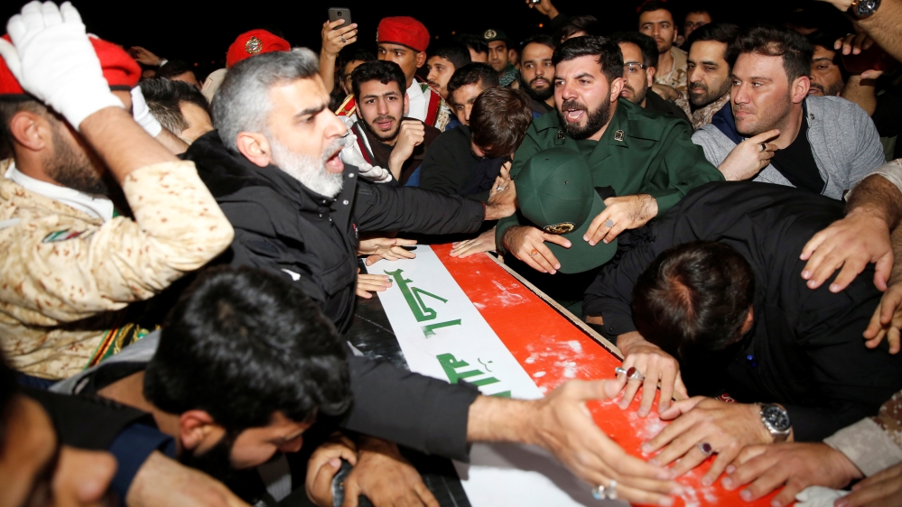 Iranian mourners react over the coffin of the Iraqi militia commander Abu Mahdi al-Muhandis, at Ahvaz international airport, in Ahvaz
