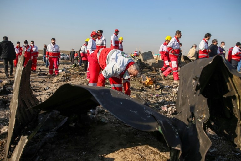 Red Crescent workers check the debris from the Ukraine International Airlines plane on the outskirts of Tehran, Iran January 8. Nazanin Tabatabaee/WANA