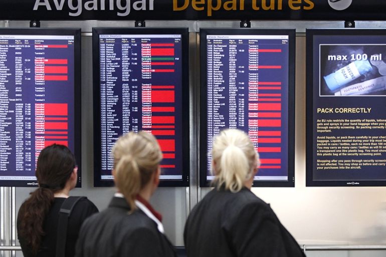 Travelers and airline staff check the departure board as flights continued to be delayed and cancelled at Stockholm''s Arlanda Airport April 19, 2010.