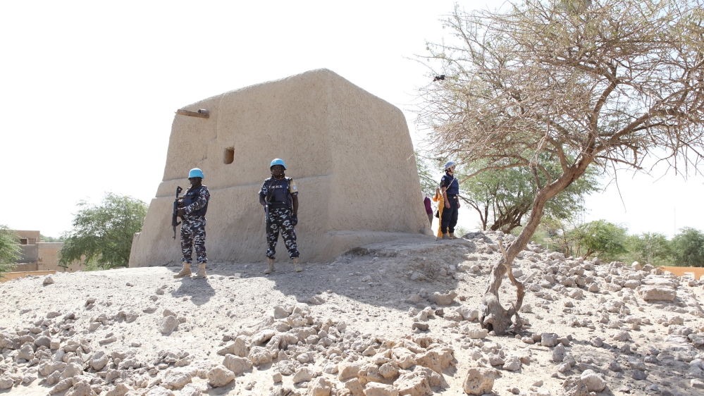 UN peacekeepers stand next to the mausoleum of Alpha Moya on February 4, 2016 in Timbuktu. Mali's fabled city of Timbuktu on February 4 celebrated the recovery of its historic mausoleums, destroyed du