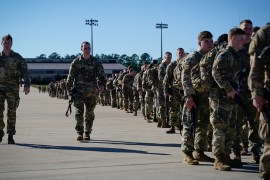 U.S. Army paratroopers assigned to the 1st Brigade Combat Team, 82nd Airborne Division, walk toward an awaiting aircraft prior to departing for the Middle East from Fort Bragg, North Carolina, U.S. Ja