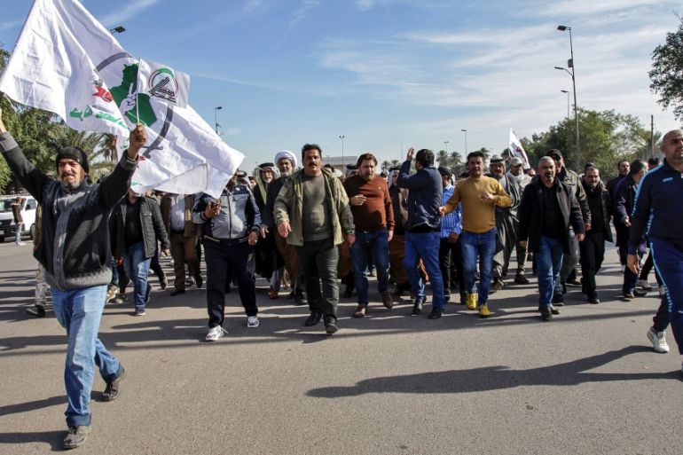 Pro-Iranian militiamen and their supporters chant slogans against the U.S. as they arrive in front of the U.S. embassy in Baghdad, Iraq, Wednesday, Jan. 1, 2020. U.S. troops fired tear gas on Wednesda