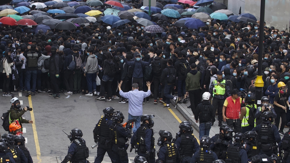 Swat police corner protesters calling for electoral reforms and a boycott of the Chinese Communist Party in Hong Kong, 