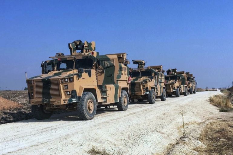 Turkish army''s armoured vehicles wait as Turkish and Russian military officials speak at the Turkey-Syria border near Kiziltepe, Mardin province, Turkey, Friday, Nov. 1, 2019. Turkey and Russia forces
