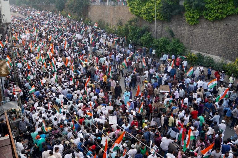 Demonstrators hold placards and flags as they attend a protest rally against a new citizenship law, in Hyderabad