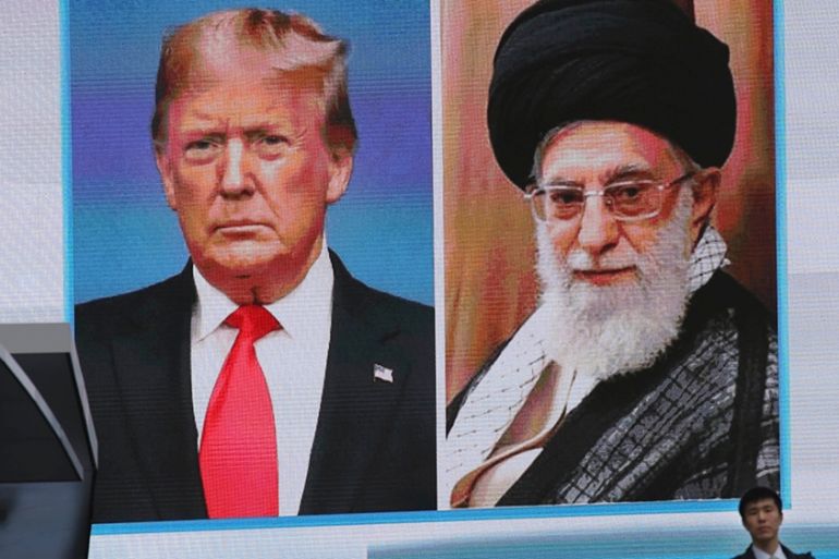 A man walks by a huge screen showing U.S. President Donald Trump, left, and Iranian Supreme Leader Ayatollah Ali Khamenei in Tokyo, Wednesday, Jan. 8, 2020. (AP Photo/Koji Sasahara)