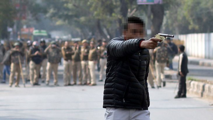 The suspect brandishing a gun during the protest against new citizenship law outside a university in Delhi [Danish Siddiqui/Reuters]