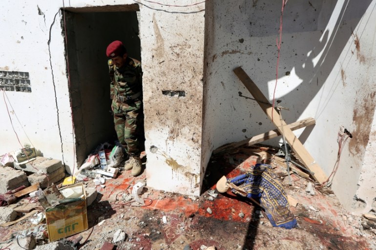 A soldier stands at the site of a Houthi missile attack on a military camp’s mosque in Marib